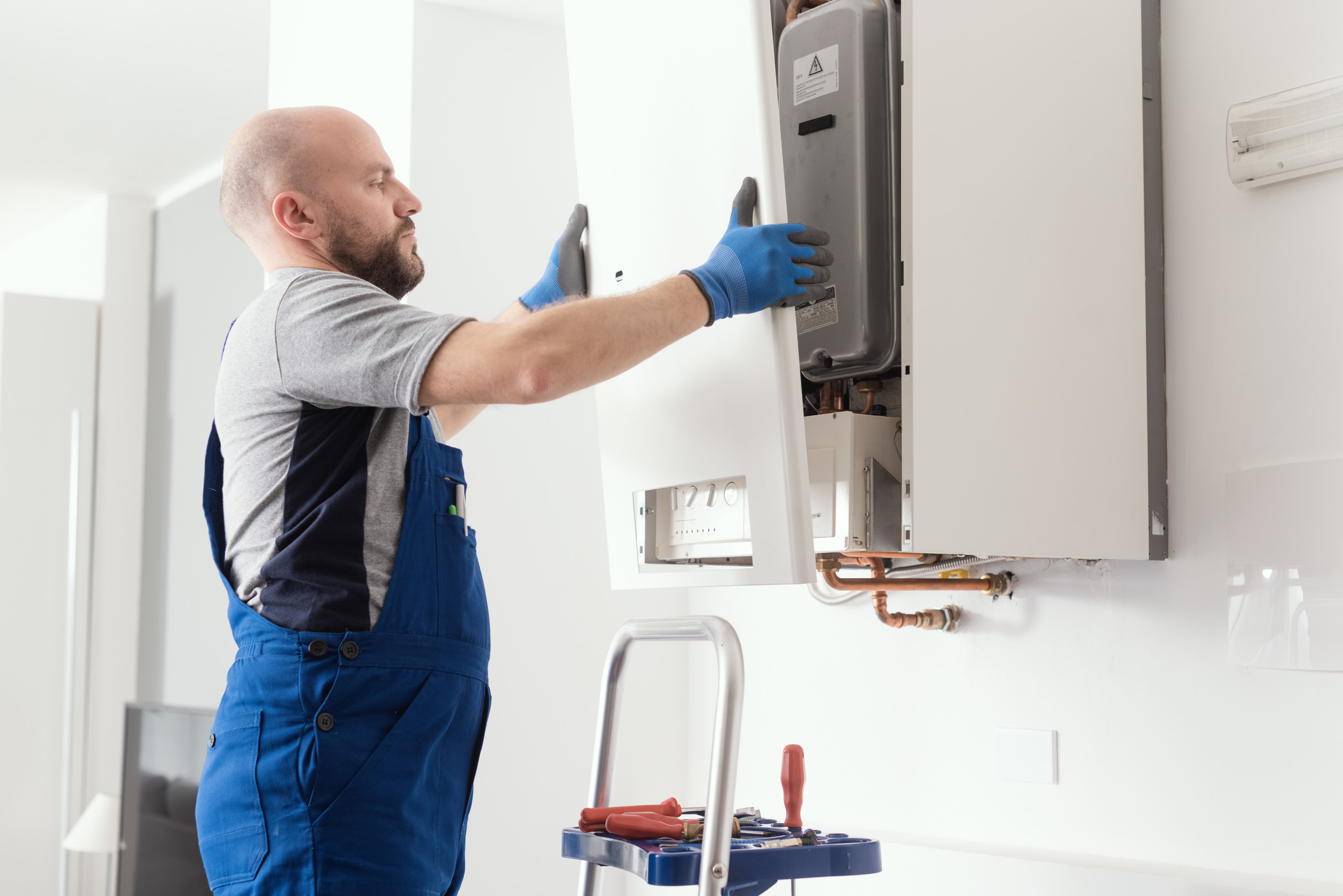 Licensed technician performing water heater installation in El Cajon home