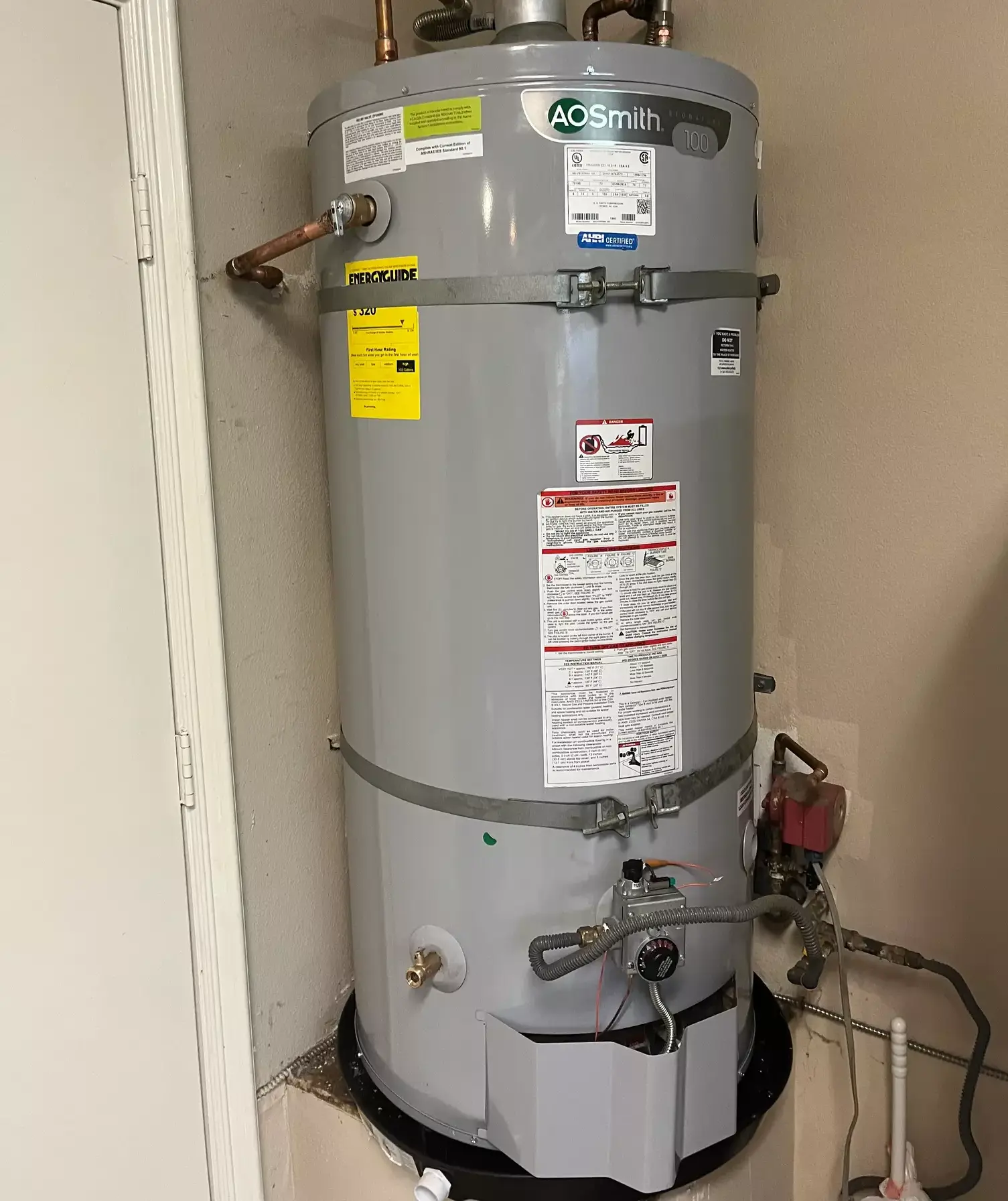 Modern tank water heater installed in garage