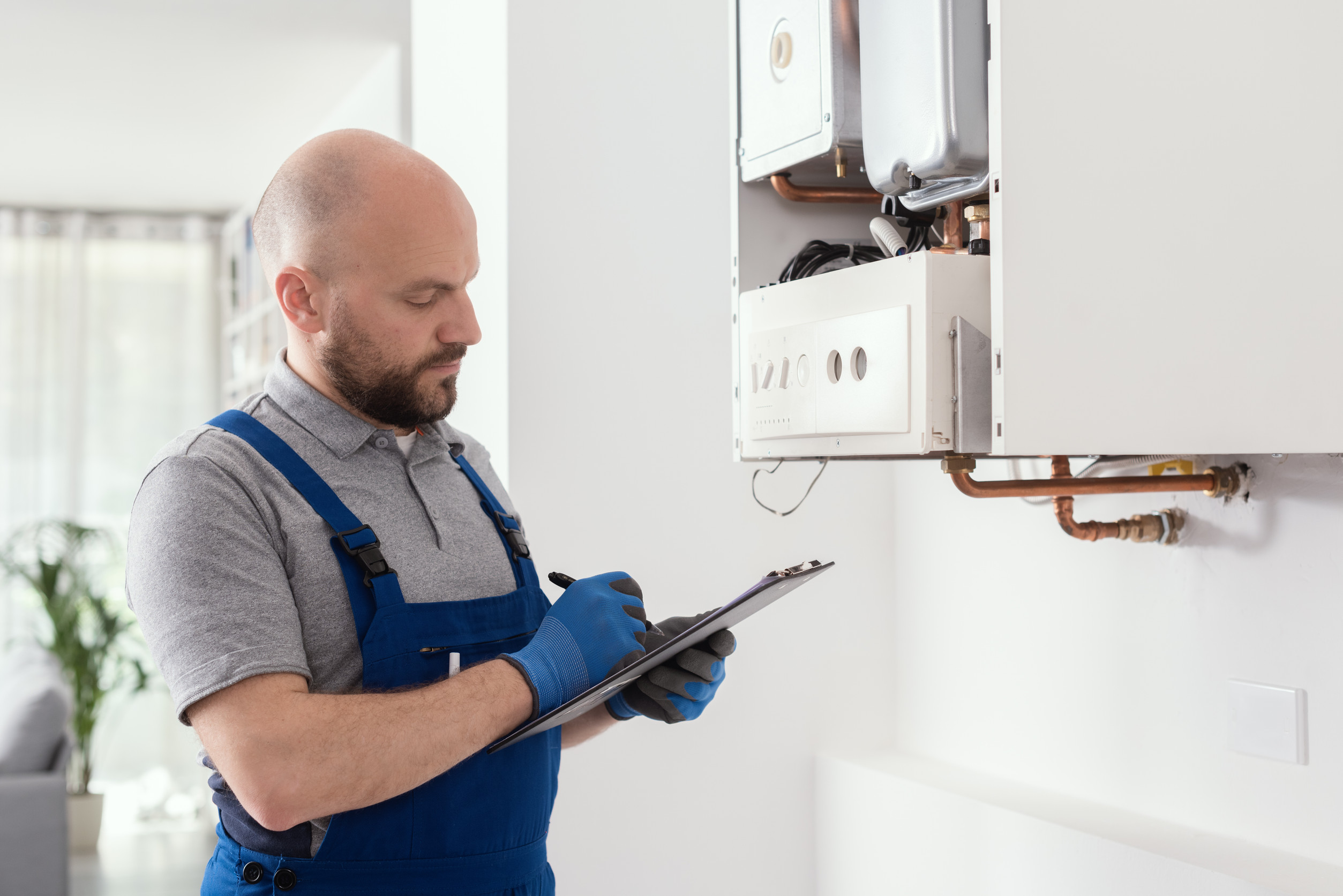 Professional plumber checking water heater installation